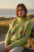 Model wearing green floral sweater outdoors